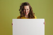 © Alliance - smiling modern woman showing blank board isolated on green