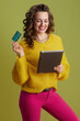 © Alliance - happy fit woman using tablet PC on green background