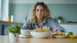 © artzone - Young Woman with Curly Hair Contemplating a Healthy Meal