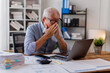 © David - Sad gray-haired architect Senior man working in modern office at computer, businessman thinking about failures,Sad, unhappy, Worried, Depression, or employee life stress concept