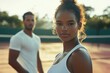© TuruMuru - Black female athlete and male partner playing tennis outdoors for fitness and training