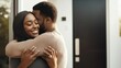 © Pixora Labs - Happy African American couple hugging each other in their new home