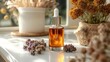 © tydeline - Natural Essential Oil Bottle with Dried Flowers on Windowsill