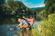 © Volodymyr - Portrait of cheerful senior man fishing. Grandfather and son fishermans. Young man and an old man fishing for spinnings on the river or lake. Catching fish.