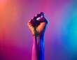 © chysakibahmed - Raised rainbow fist of a woman for PRIDE month and the LGBTQIA+ movement. Pride day for sexuality freedom, love diversity celebration and the fight for human rights Stock Photo photography