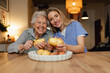 © Halfpoint - Portrait of elderly companion assistant and senior woman peeling potatoes. Home health care services.