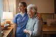 © Halfpoint - Caring healthcare worker visiting a senior patient at home, hugging her.