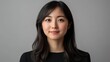 © velikiyzayats - Portrait of a Young East Asian Woman with Long Dark Hair in a Minimalistic Studio Setting, Exuding Confidence and Poise