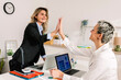 © Westend61 - Happy successful businesswomen giving high-five to each other at desk in office