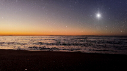 Wall Mural - a movement of stars in the night sky with the view of mountains..