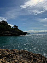 Poster - Sea bay blue shiny waters and rocky coastline. 