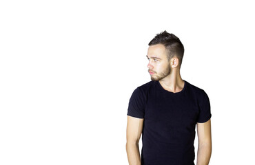 Poster - Young man with a neat hairstyle and beard wearing ashirt, standing and looking to the side on a clean white background