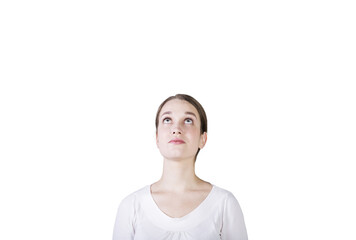 Poster - A woman in a white shirt gazes upward with a thoughtful expression, isolated on a white background. Concept of curiosity, thinking, or inspiration