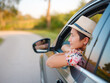 © YURII Seleznov - Traveler woman in red ethnic dress and hat drives car through scenic countryside of Croatia in summer. Surrounded by lush fields and forests, she enjoys peaceful and adventurous road trip