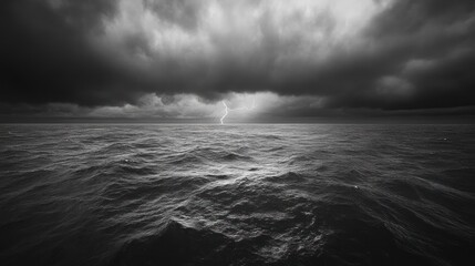 a lightning striking in the distance over an ocean, with dark clouds overhead creating dramatic ligh