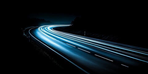 Wall Mural - Streaks of Blue Light Trail Across a Winding Highway at Night, Long Exposure Photography