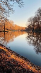 Wall Mural - serene sunset over calm lake surrounded by trees and reflections in tranquil atmosphere