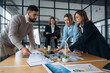 © standret - Power management in wind turbine company. Business people are working in the office