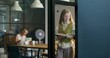 © m-art - Two women are talking walking around the office. They use a tablet and read documents. Daylight