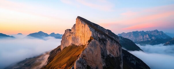 Wall Mural - Mountain peak nature idea. A stunning mountain peak rising above the clouds at sunrise, showcasing vibrant colors.