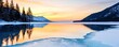 © PBMasterDesign - Frozen lake nature concept. A serene winter landscape featuring snow, frozen lake, and colorful sunset reflections.