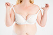 © staras - Large natural saggy breasts after breastfeeding in a lace push-up bra close-up, big boobs on white background, augmentation and plastic surgery concept
