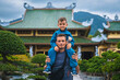 © alexkoral - Happy family of tourists dad and son at Buddhist temple at Linh Ung Pagoda in Da Nang in Vietnam. Travel and tourism in Asia