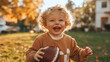 © Ирина Щукина - A young child is holding a football and smiling