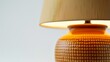 © adnan - A close-up shot of a decorative lamp with a textured ceramic base and soft, warm light emitting from the shade, isolated against a pure white background, highlighting every intricate detail.