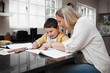 © peopleimages.com - Teaching, mother and child with homework in kitchen for school task, creative development or growth support. Education, woman and helping student with drawing for art lesson, learning or care in home