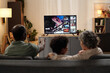 © pressmaster - Watching Television Together in a Cozy Living Room