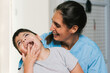 © Jordi Mora - Physiotherapist assisting a child with cerebral palsy smiling and having fun