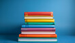 © Brooklyn - a close up shot of a stack of textbooks with colourful covers arranged neatly against a stable blue backdrop symbolizing the excitement of getting to know v 6 zero photograph 2 ban me