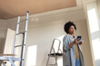 © ReeldealHD images - Smiling woman on phone during home improvement