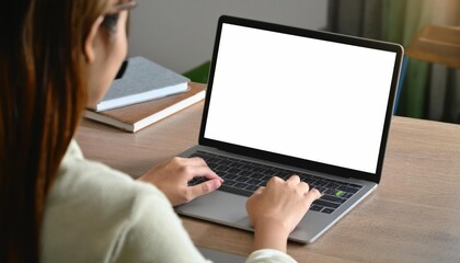 young woman using computer laptop in front of an blank white computer screen in home 