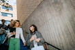 © Maskot - Low angle view of happy female students talking while moving down from stairs