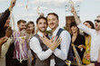 © Maskot - Portrait of newly married gay couple showing rings at wedding ceremony