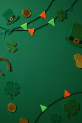 Wall Mural - St. Patrick's Day background with bunting , shamrocks, leprechaun hats, gold coins, and a horseshoe on a green backdrop