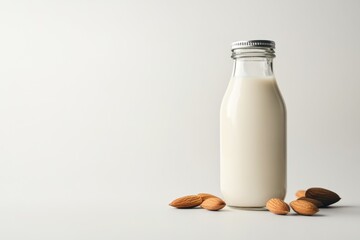 Wall Mural - Glass bottle of almond milk with almonds