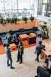 © Maskot - High angle view of male and female business delegates discussing with each other at networking event