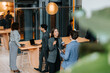 © Maskot - Female entrepreneur discussing with male delegate at networking event