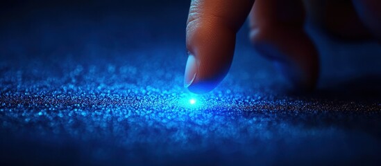 Wall Mural - futuristic touch interaction with glowing blue light on textured surface in dark ambient setting