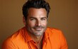 © hakule - A man with a beard and gray hair is wearing an orange shirt