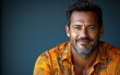 © hakule - A man with a mustache and a floral shirt is smiling