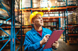 © Davor - Warehouse supervisor inspecting inventory with clipboard in storage facility