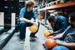 © Davor - Warehouse workers taking a break sitting near forklift in storage facility
