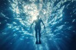 © arthurhidden - Silhouette of underwater diver with flippers against the sunlight in blue water