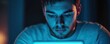© STwul - Man using tablet at night, blue light, home background