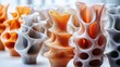 © Tyrah - Colorful 3D-printed vases arranged artistically on a table with soft natural light