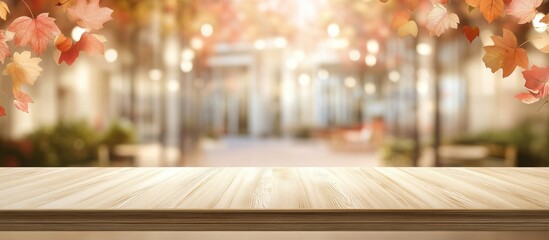 Wall Mural - wooden table with blurred autumn foliage and bokeh lights background with copy space